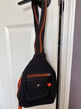 Black and Orange woman’s sling/backpack with Contrast Stitching